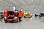 Reflections in the very polished tiled floor of McLaren MP4-12C sports cars in build